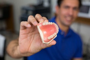 Dental technician presenting dental prosthesis